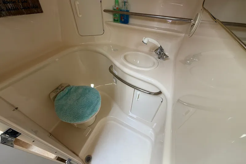 Slide: The Image of Bathroom interior of 1999 Sea Ray Sundancer 330 yacht, featuring sink and toilet. - 32