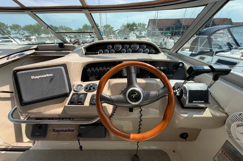 Slide: The Image of 1999 Sea Ray Sundancer 330 helm with Raymarine navigation and wooden steering wheel. - 17