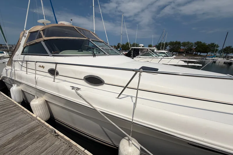 Slide: The Image of 1999 Sea Ray Sundancer 330 docked at marina under clear sky. - 9