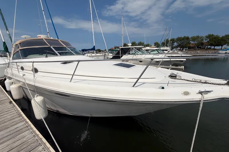 Slide: The Image of 1999 Sea Ray Sundancer 330 docked at marina under clear blue sky. - 7