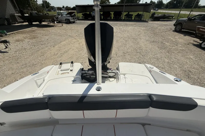 Slide: The Image of 2023 Tahoe 2150 CC boat rear view with outboard motor in a gravel lot. - 11