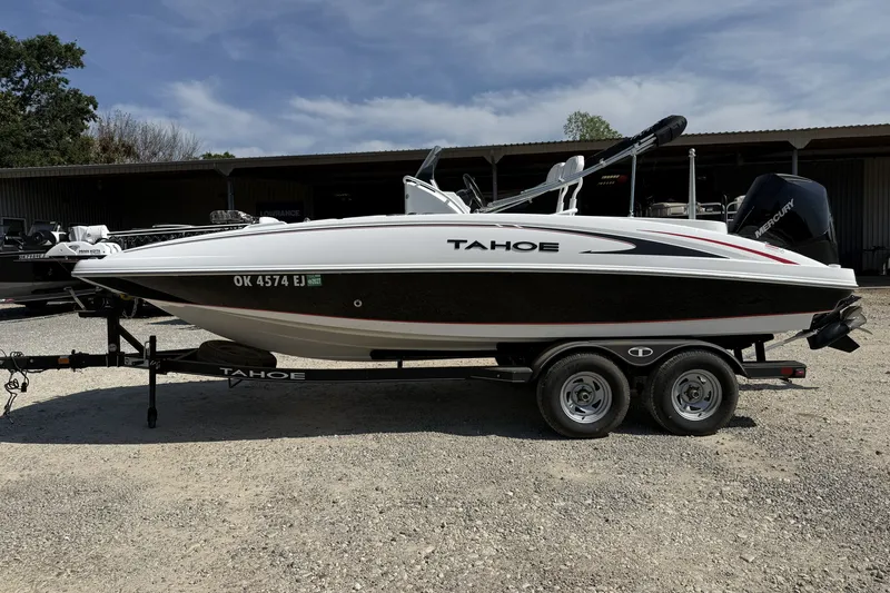 Slide: The Image of 2023 Tahoe 2150 CC boat on trailer, parked outdoors under clear sky. - 4