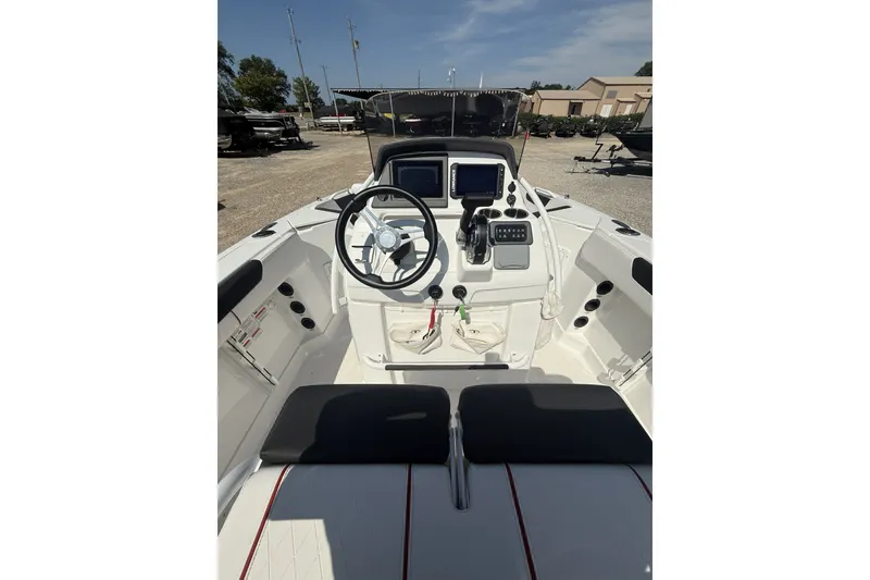 Slide: The Image of 2023 Tahoe 2150 CC boat cockpit with steering wheel and control panel. - 10