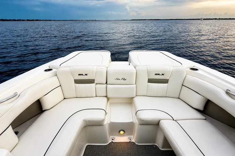 Slide: The Image of 2006 Sea Ray 270 SLX boat interior with white seating on calm water. - 22
