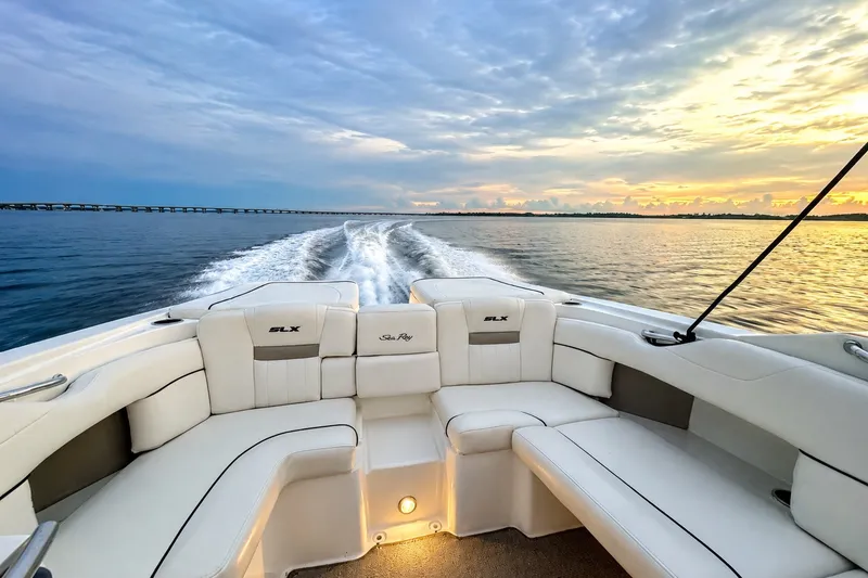 Slide: The Image of 2006 Sea Ray 270 SLX boat cruising on open water at sunset. - 7