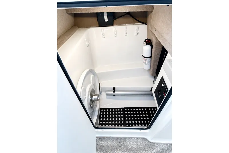 Slide: The Image of Interior of 2006 Sea Ray 270 SLX boat, featuring storage space and safety equipment. - 15