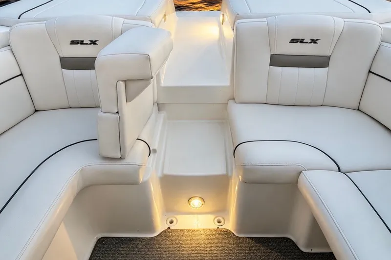 Slide: The Image of Luxurious white seating on a 2006 Sea Ray 270 SLX boat, featuring ambient lighting. - 23