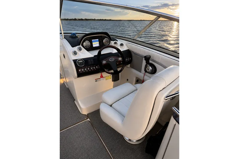 Slide: The Image of Interior view of 2006 Sea Ray 270 SLX boat cockpit with steering wheel and controls. - 10