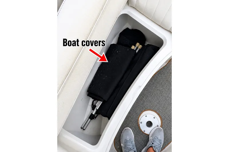 Slide: The Image of Storage compartment on 2006 Sea Ray 270 SLX boat holding black boat covers. - 31
