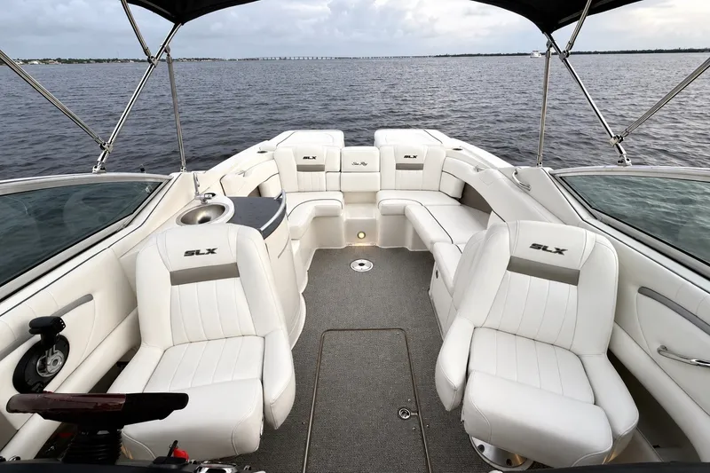 Slide: The Image of Interior view of a 2006 Sea Ray 270 SLX boat with luxurious white seating. - 29