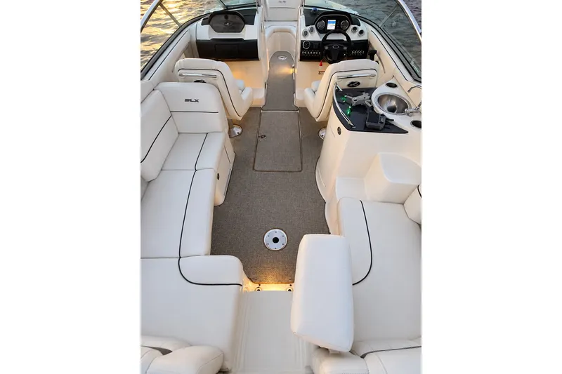 Slide: The Image of 2006 Sea Ray 270 SLX boat interior with white seating and modern dashboard. - 24