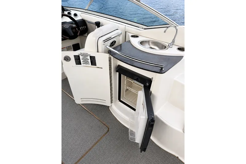 Slide: The Image of 2006 Sea Ray 270 SLX boat interior with sink and mini fridge. - 11