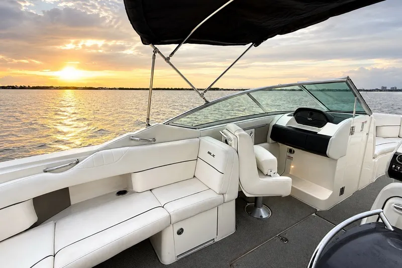 Slide: The Image of 2006 Sea Ray 270 SLX boat interior at sunset on calm water. - 27