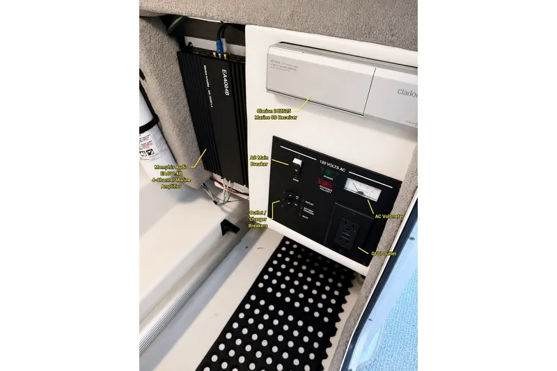 Slide: The Image of Electrical panel of a 2006 Sea Ray 270 SLX with audio and power components. - 16