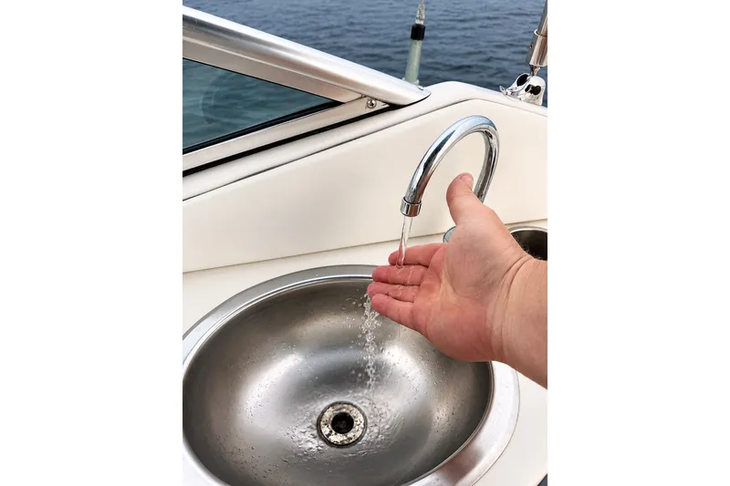 Slide: The Image of Hand under running water in a Sea Ray 270 SLX boat sink, 2006 model. - 12