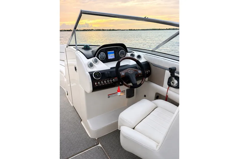 Slide: The Image of Cockpit of 2006 Sea Ray 270 SLX boat with steering wheel and control panel. - 9