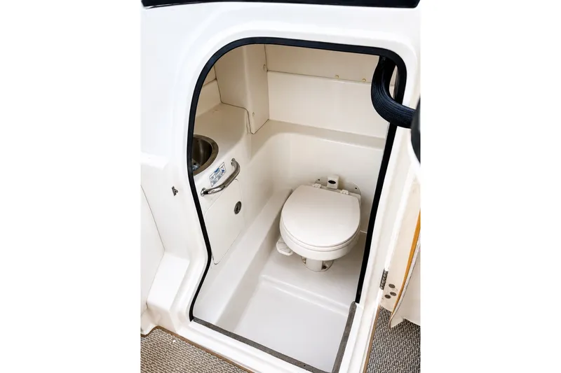 Slide: The Image of 2006 Sea Ray 270 SLX boat interior with compact marine toilet. - 19