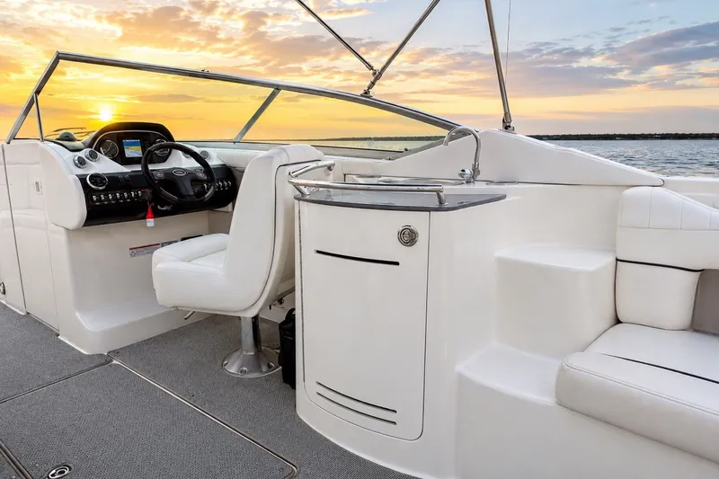 Slide: The Image of 2006 Sea Ray 270 SLX boat interior with helm, seating, and sunset view. - 8