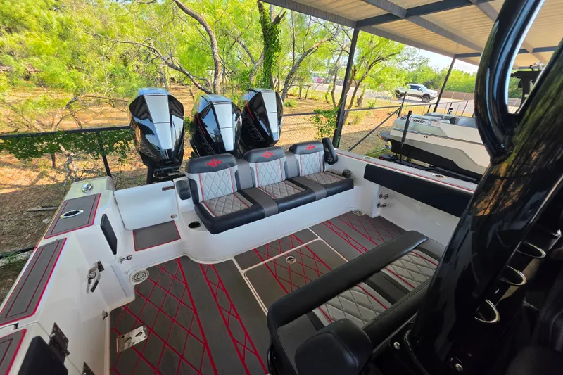 Slide: The Image of 2024 Fountain 38 SC boat interior with triple outboard engines and stylish seating. - 18
