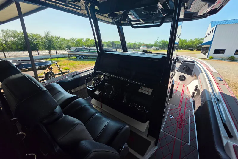 Slide: The Image of 2024 Fountain 38 SC boat interior with sleek black seating and modern dashboard. - 9