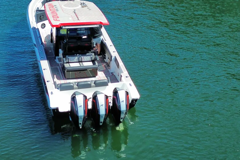 Slide: The Image of 2024 Fountain 38 SC boat with triple outboard engines on clear water. - 6