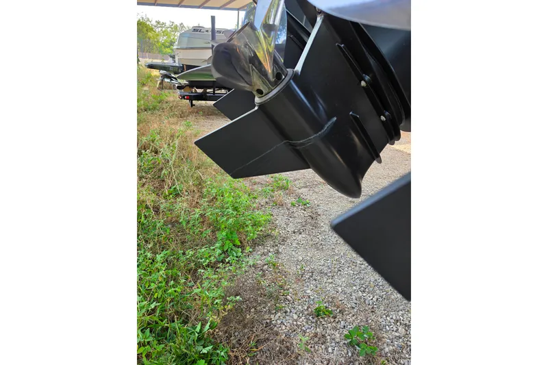 Slide: The Image of Close-up of 2024 Fountain 38 SC boat propeller, parked on gravel with greenery nearby. - 10