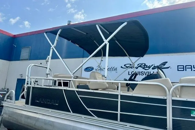 Slide: The Image of 2017 Landau Island Breeze 212 Cruise pontoon boat with canopy, parked near dealership. - 14