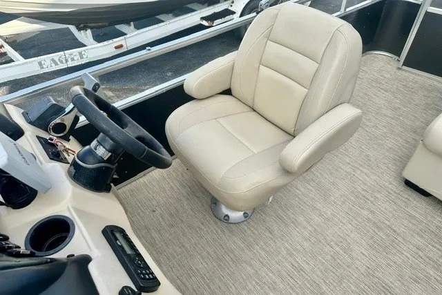 Slide: The Image of Captain's chair on 2017 Landau Island Breeze 212 Cruise pontoon boat, featuring beige upholstery. - 8