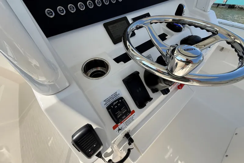 Slide: The Image of 2024 Regulator 28 boat helm with steering wheel and control panel. - 16