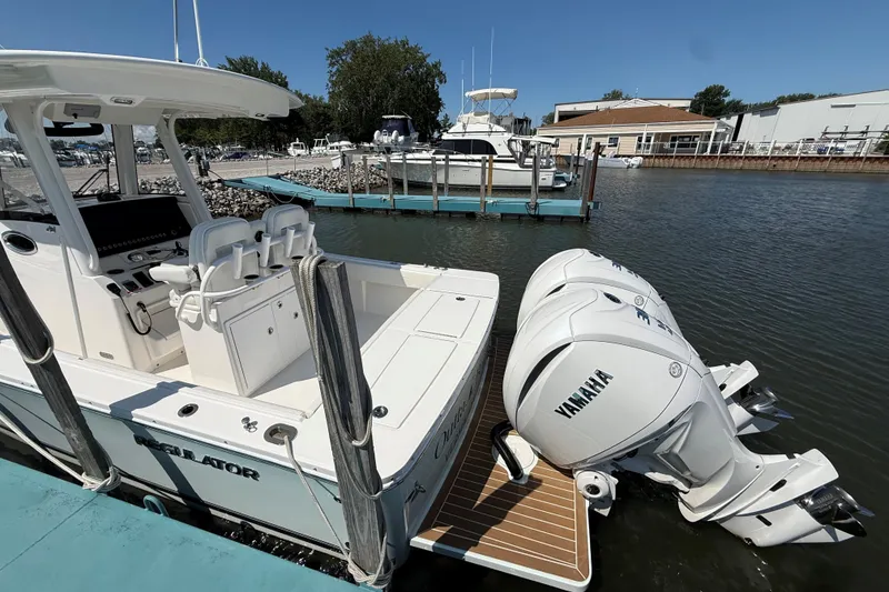 Slide: The Image of 2024 Regulator 28 boat with Yamaha engines docked at a marina. - 5
