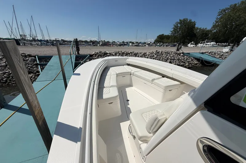 Slide: The Image of 2024 Regulator 28 boat with spacious seating at a marina dock. - 8