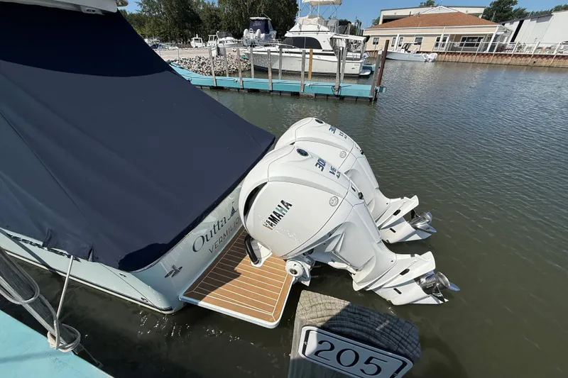 Slide: The Image of 2024 Regulator 28 boat with Yamaha engines docked at marina. - 27
