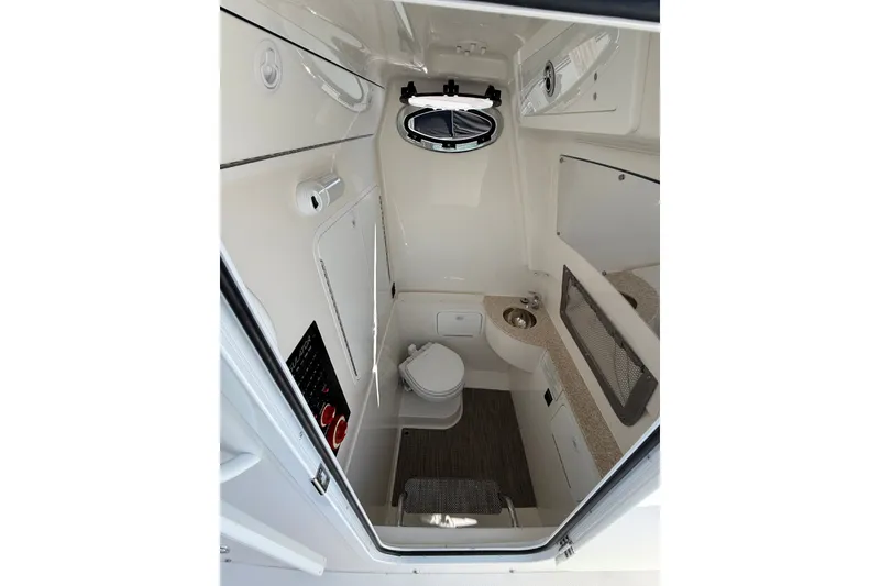 Slide: The Image of 2024 Regulator 28 boat interior cabin with toilet and sink. - 28