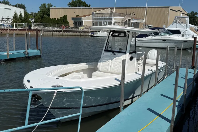 Slide: The Image of 2024 Regulator 28 boat docked in a marina, featuring sleek design and modern amenities. - 4