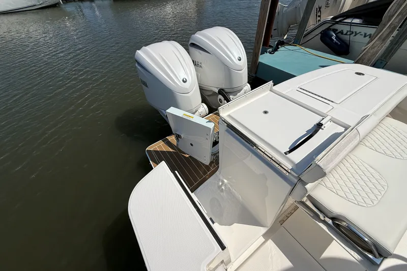 Slide: The Image of 2024 Regulator 28 boat with twin Yamaha outboard engines docked at marina. - 19