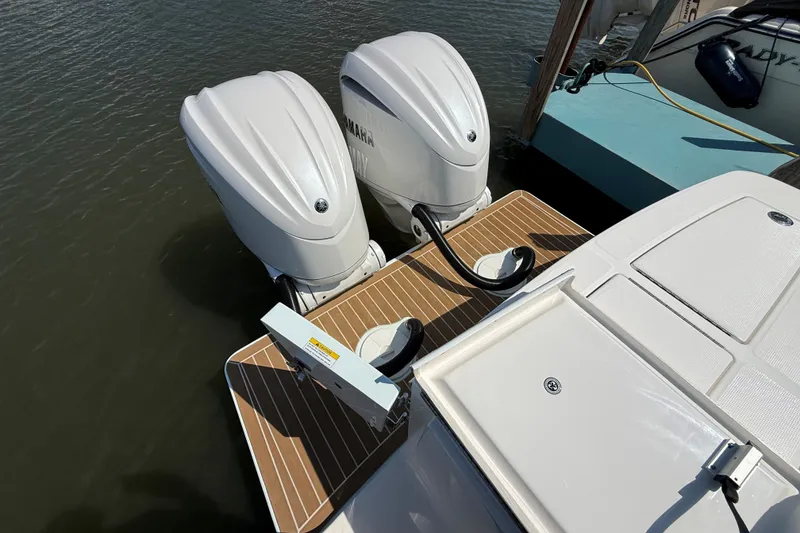 Slide: The Image of 2024 Regulator 28 boat with dual Yamaha outboard engines at dock. - 20