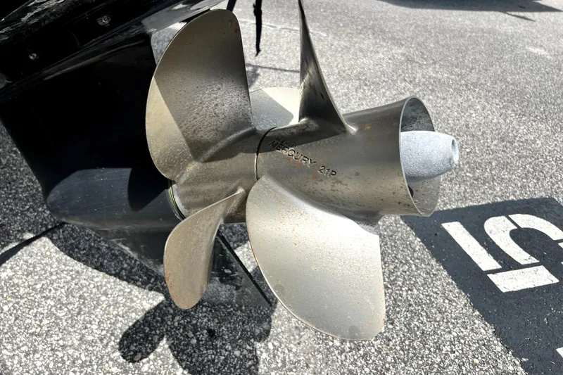 Slide: The Image of Propeller of 2010 Sea Ray 240 Sundancer boat on asphalt surface. - 21