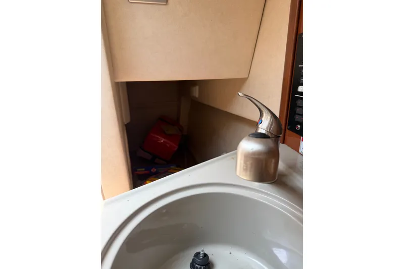 Slide: The Image of Interior view of 2010 Sea Ray 240 Sundancer boat sink and faucet area. - 13