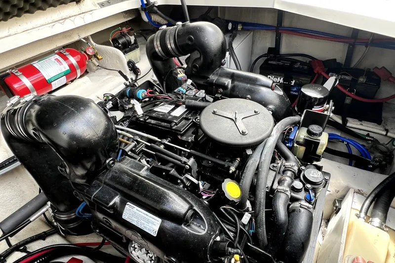 Slide: The Image of Engine compartment of a 2010 Sea Ray 240 Sundancer boat, featuring detailed components and wiring. - 20