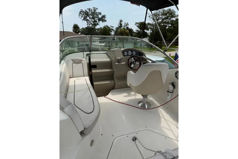 Slide: The Image of Interior view of 2010 Sea Ray 240 Sundancer boat with helm and seating area. - 3
