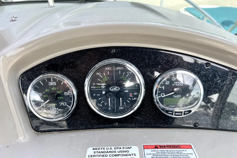 Slide: The Image of Dashboard of a 2010 Sea Ray 240 Sundancer boat with speedometer and gauges. - 42