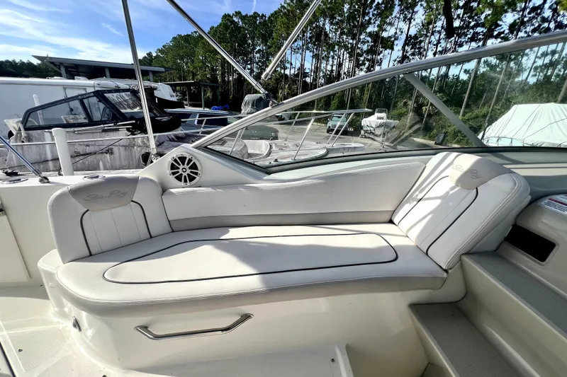 Slide: The Image of 2010 Sea Ray 240 Sundancer boat interior with white seating and speaker. - 45
