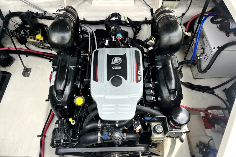 Slide: The Image of Engine compartment of a 2010 Sea Ray 240 Sundancer boat, featuring a MerCruiser 5.0L engine. - 28