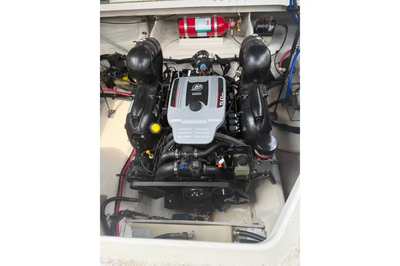 Slide: The Image of Engine compartment of a 2010 Sea Ray 240 Sundancer boat, featuring a 5.0L engine. - 16