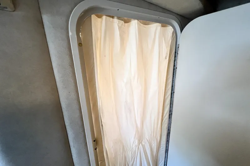 Slide: The Image of Interior view of 2010 Sea Ray 240 Sundancer cabin with curtain detail. - 71