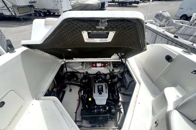Slide: The Image of Engine compartment of a 2010 Sea Ray 240 Sundancer boat, showcasing the motor and interior details. - 56