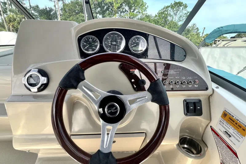 Slide: The Image of Steering wheel and dashboard of a 2010 Sea Ray 240 Sundancer boat. - 41