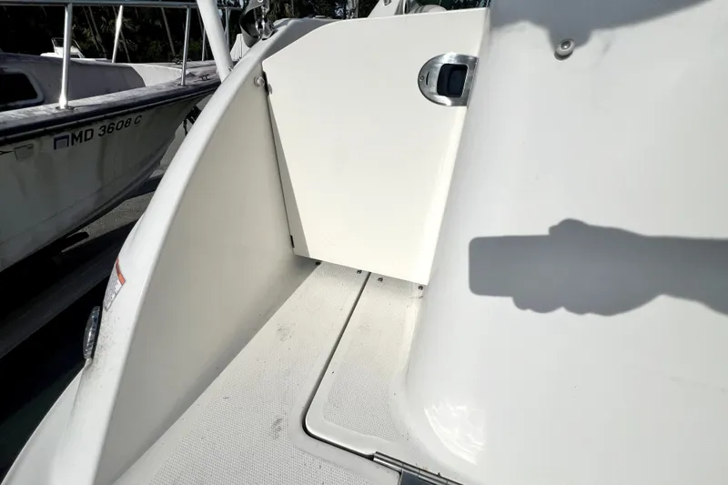 Slide: The Image of 2010 Sea Ray 240 Sundancer boat deck with open hatch and shadow. - 87