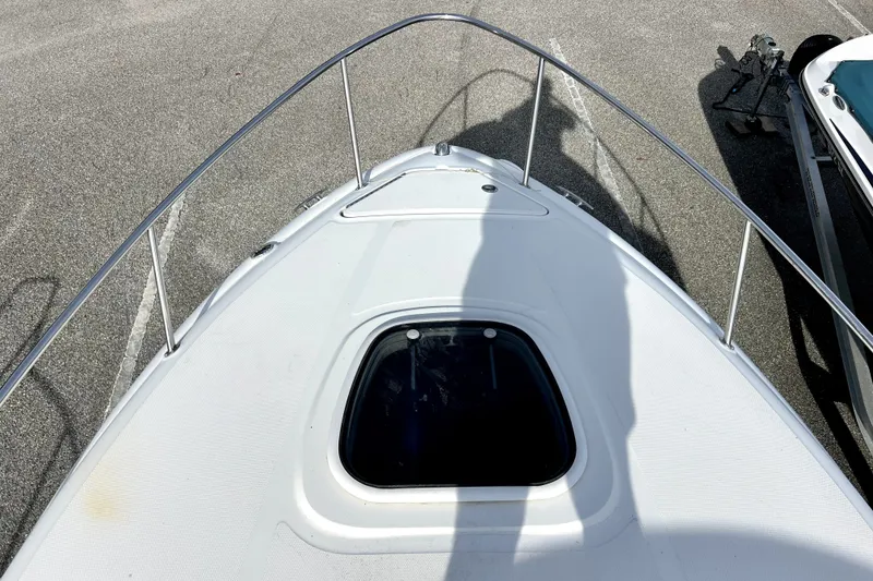 Slide: The Image of Bow view of 2010 Sea Ray 240 Sundancer boat with hatch and railing. - 36