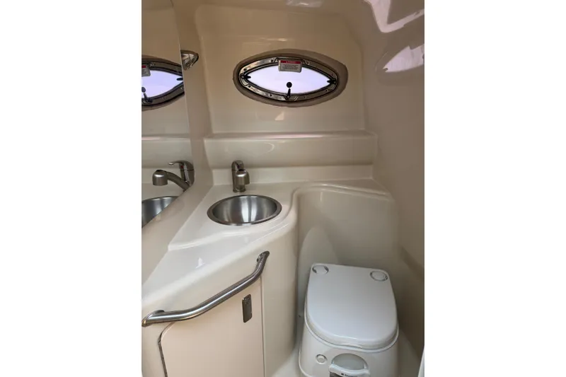 Slide: The Image of Compact bathroom in 2010 Sea Ray 240 Sundancer boat with sink and toilet. - 12